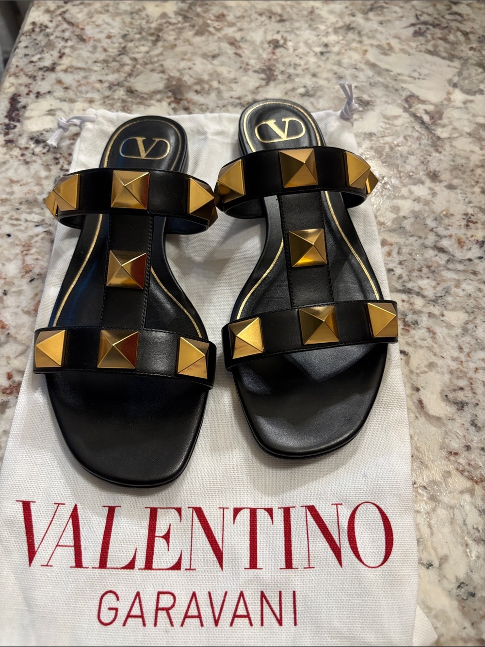 Valentino Garavani Black Leather Slide Sandals with Gold Pyramid Studs